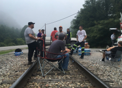 Image of a film crew on an abandoned train track. 