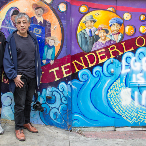 Hanmin Liu and Jennifer Mei standing by a mural that says "Tenderloin"